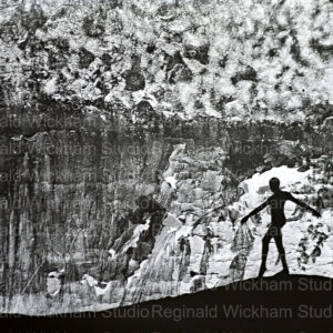 Silhouetted photograph of dancer in front of mountain in black and white