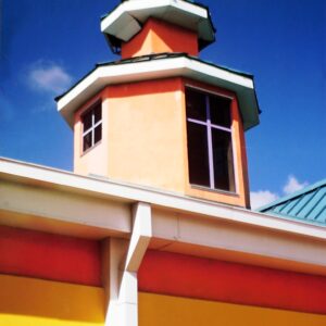 Original artistic photograph of a steeple. Picture of ocean town steeple of small building. Pink and Yellow sided short tower